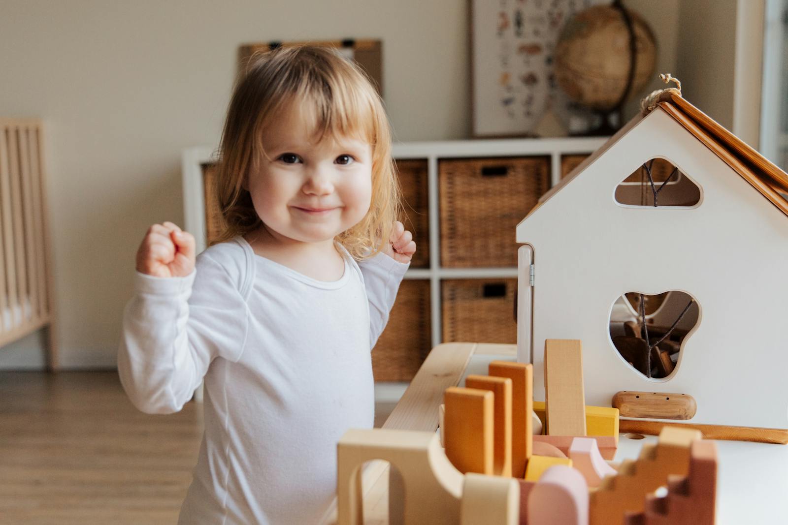 A young girl cleaning up her toys