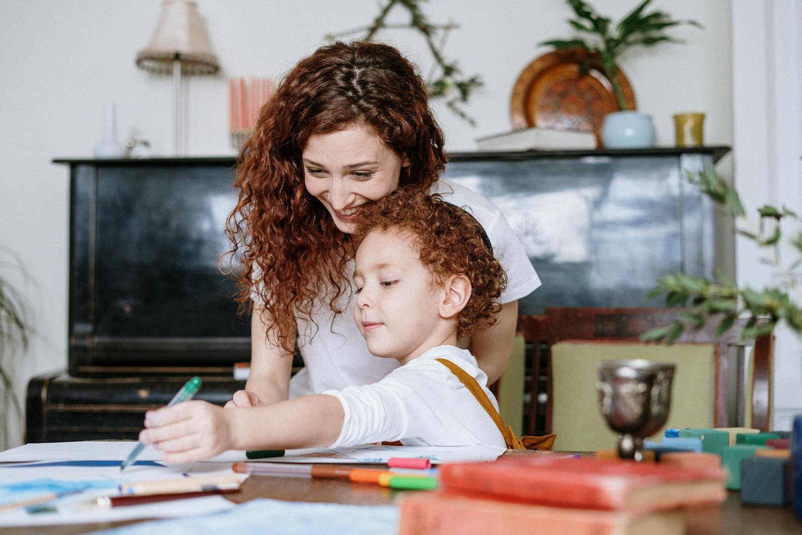 A therapist helping a young boy with a task