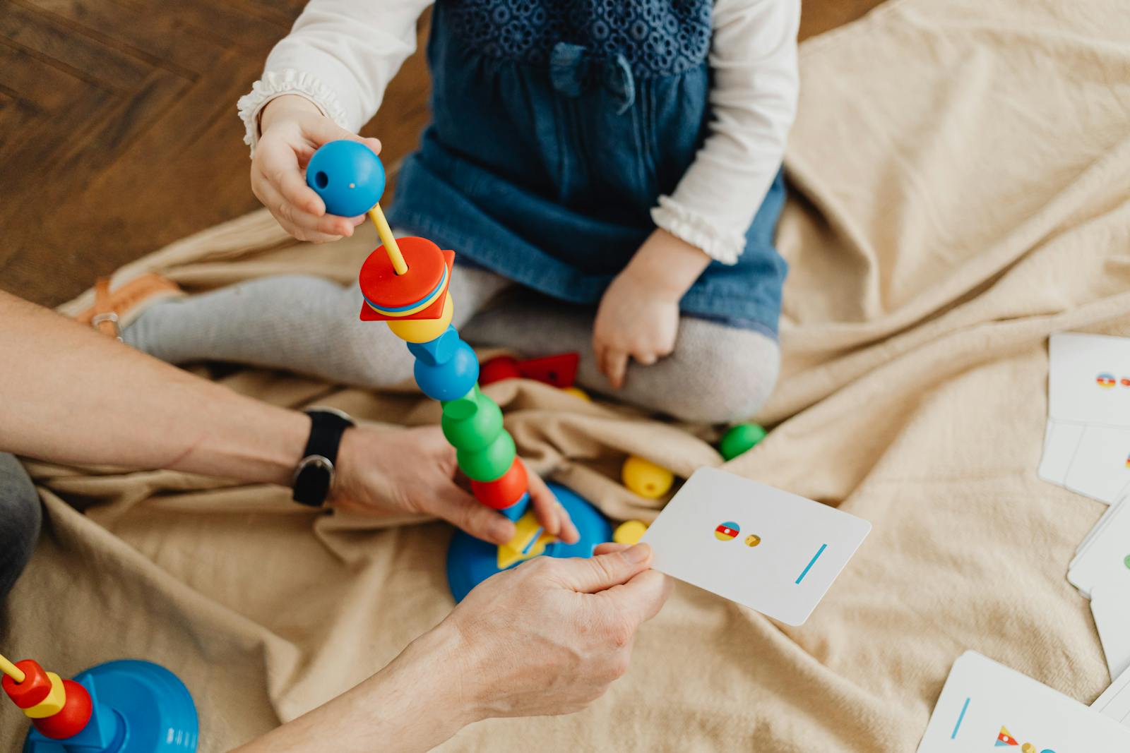 An overhead view of a child playing with toys.