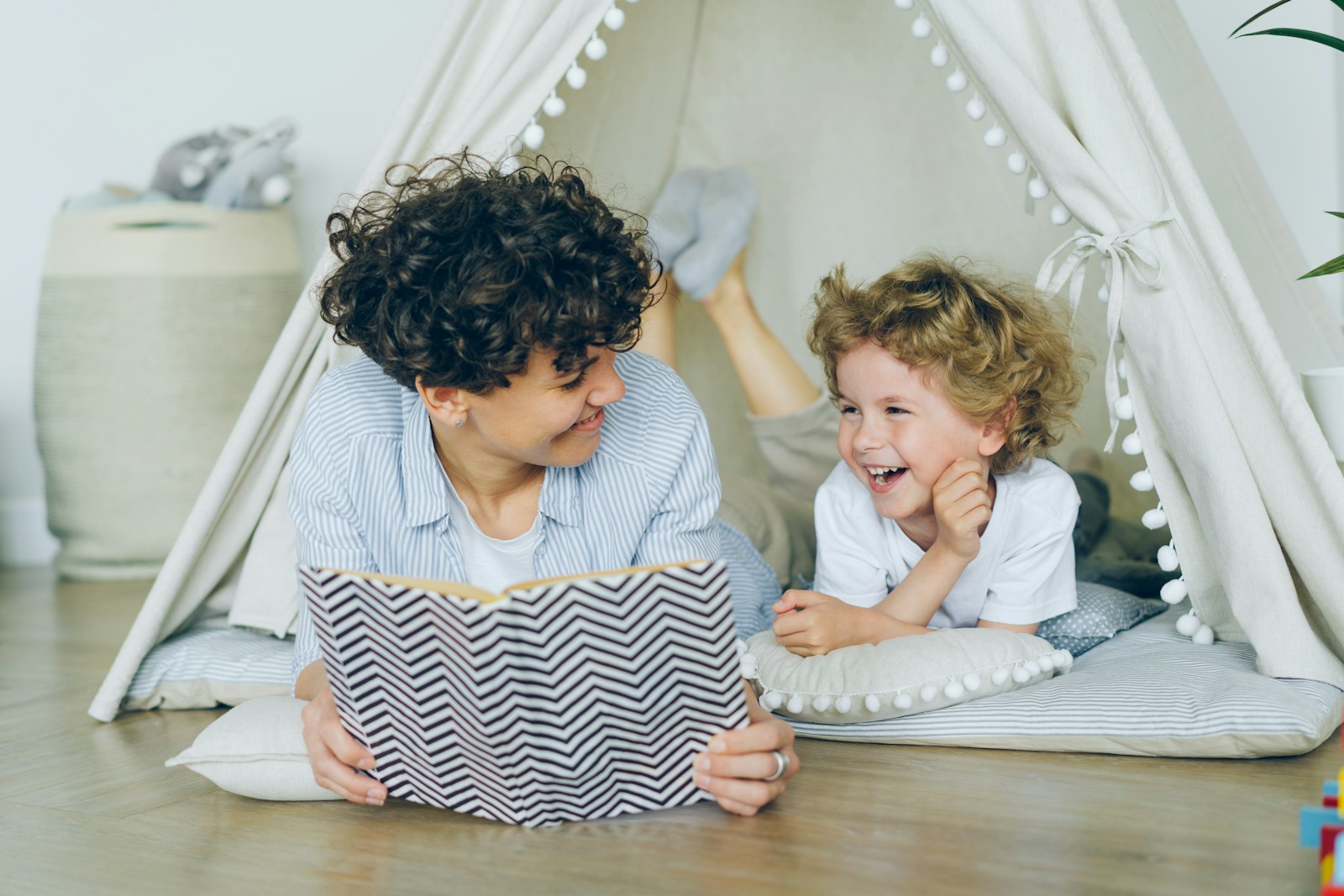 A caregiver reading a book to a young child