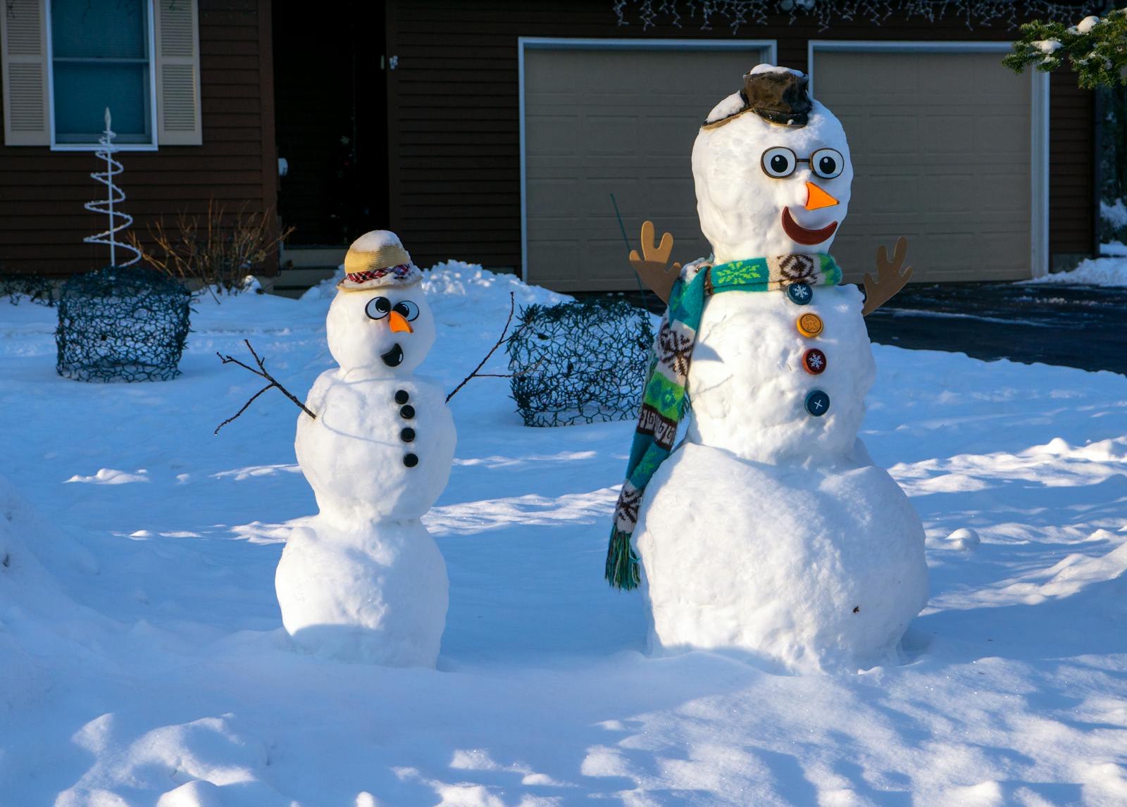 a yard with two snowmen