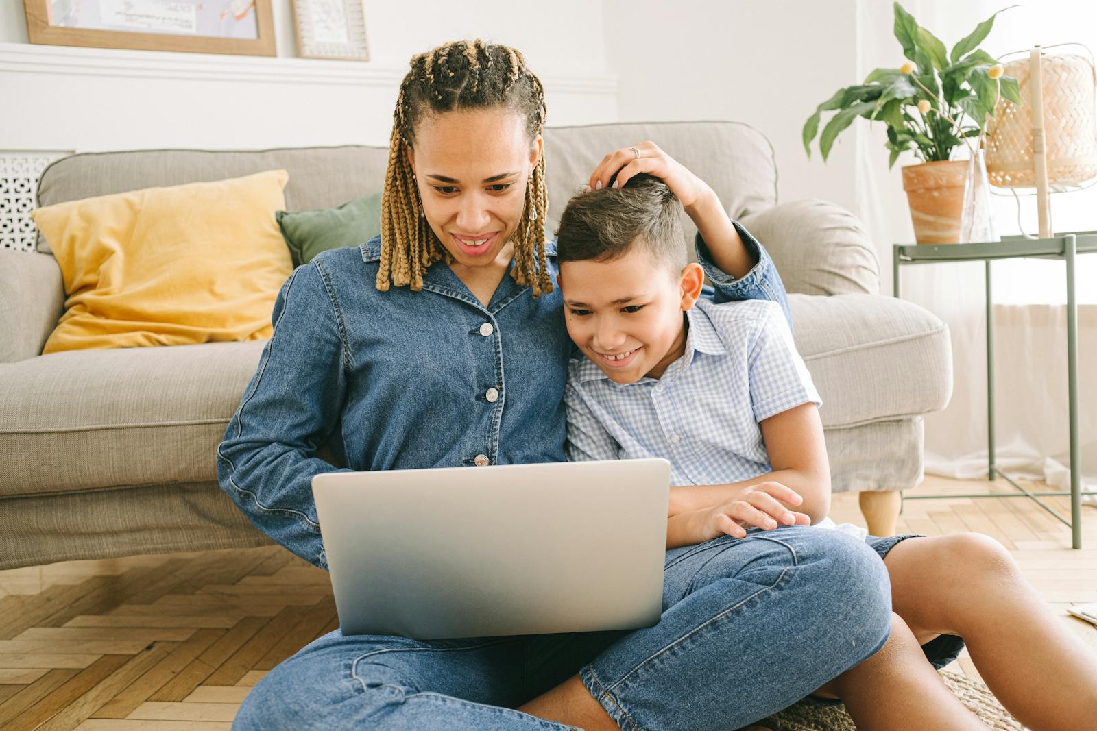 A caregiver and child prepare for ABA Therapy by watching videos about the stubject.