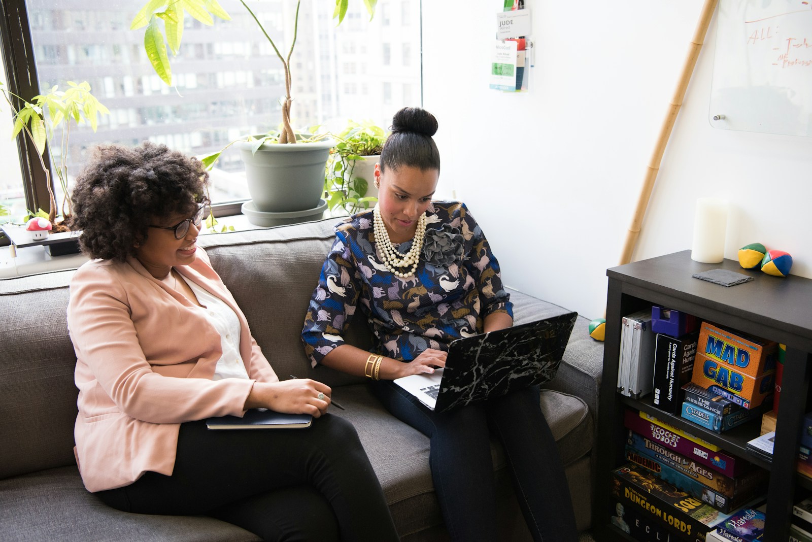 two woman siting on sofa discussing autism advocacy